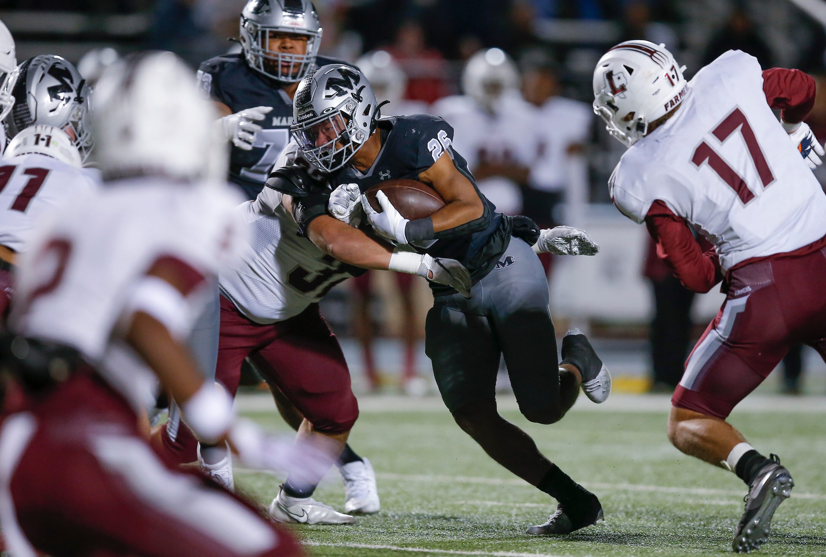 Arlington Martin junior running back Sergio Snider (26) looks for room against the...