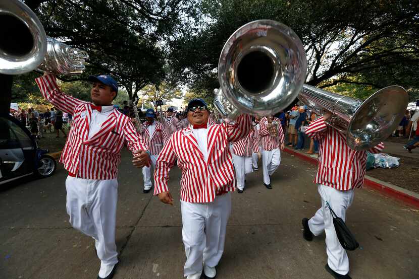 SMU band members Edwin Mendoza (left), Juan Rios (center) and Philip Sommers perform on the...