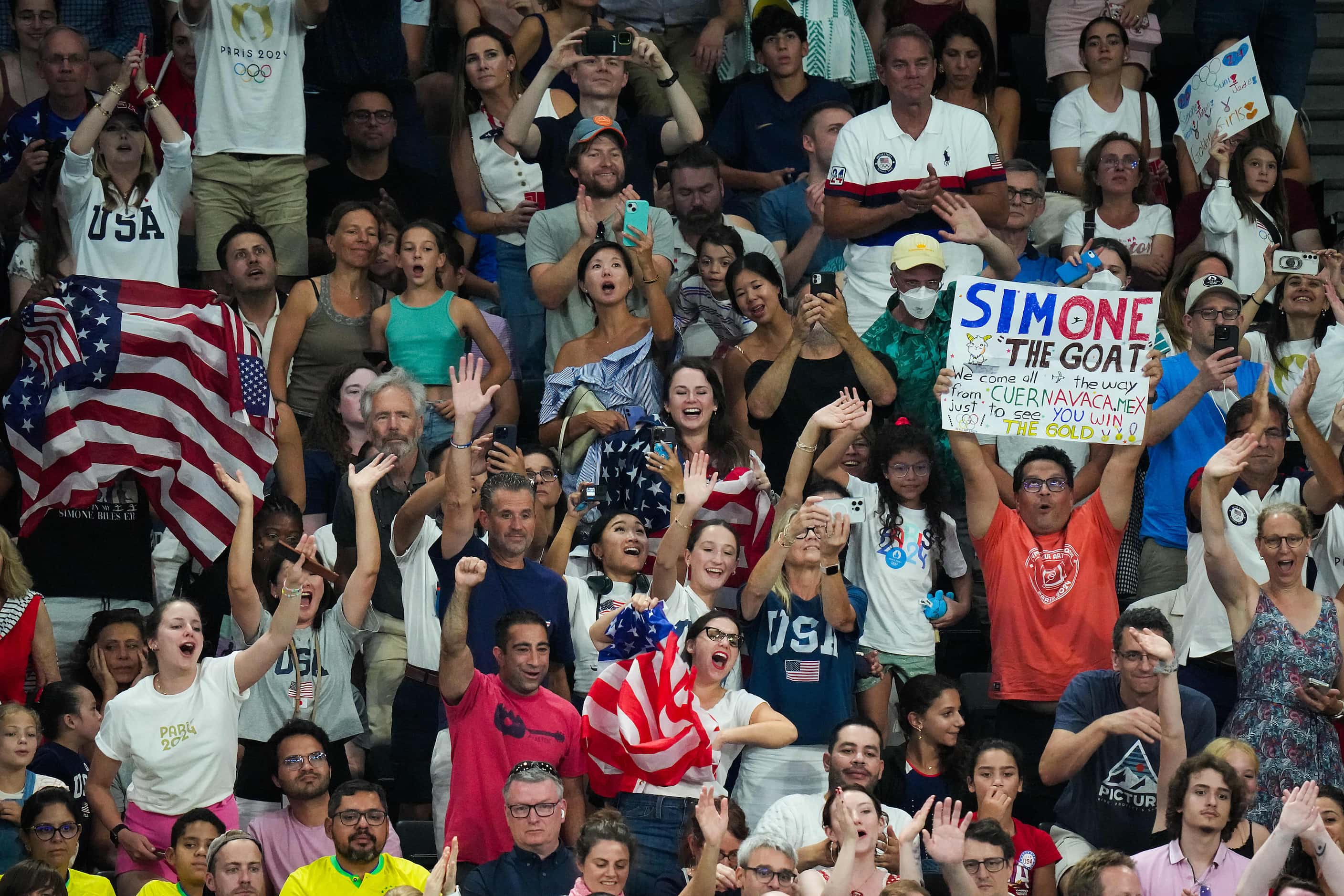 Fans cheer for Simone Biles of the United States during the women’s gymnastics all-around...