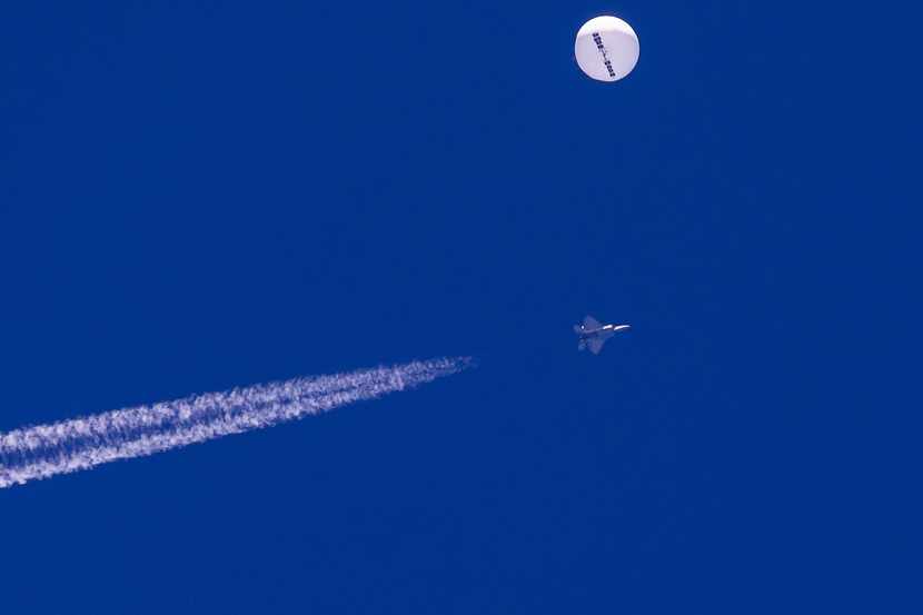 In this photo provided by Chad Fish, a large balloon drifts above the Atlantic Ocean, just...