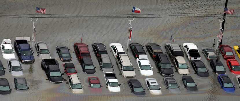 Flooded cars near the Addicks Reservoir in Houston sit as floodwaters from Tropical Storm...