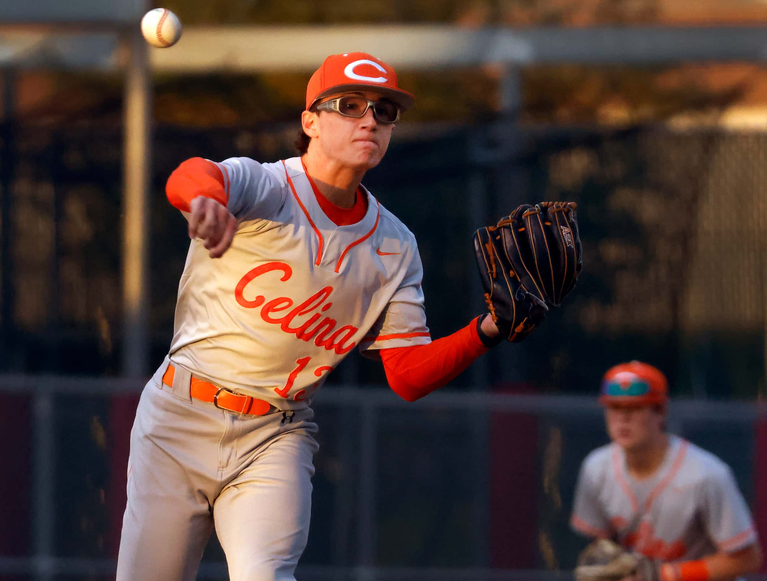 Celina High starting pitcher Brady Broeckel (13) wheels and throws to first on a third...