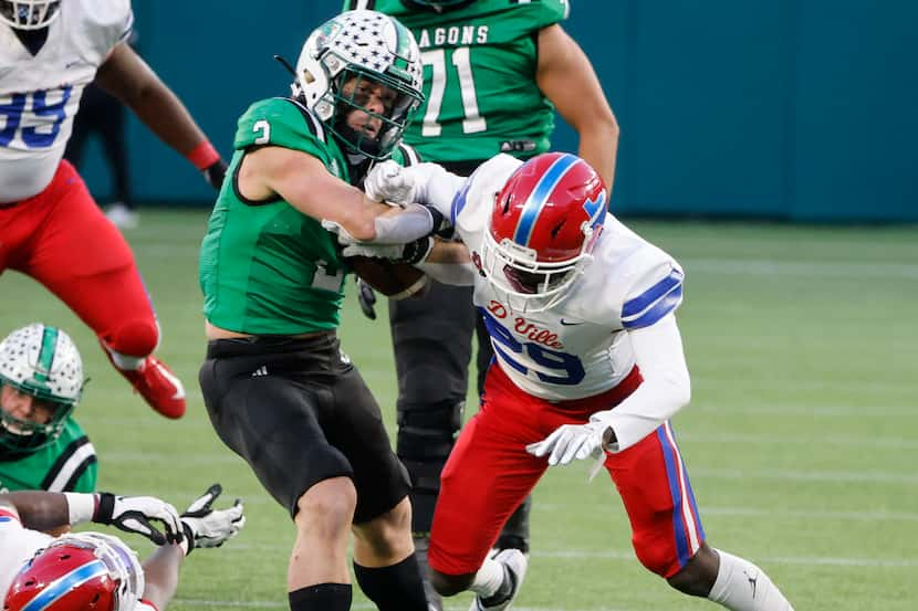 Southlake running back Owen Allen bounces off an attempted tackle by Duncanville defender...