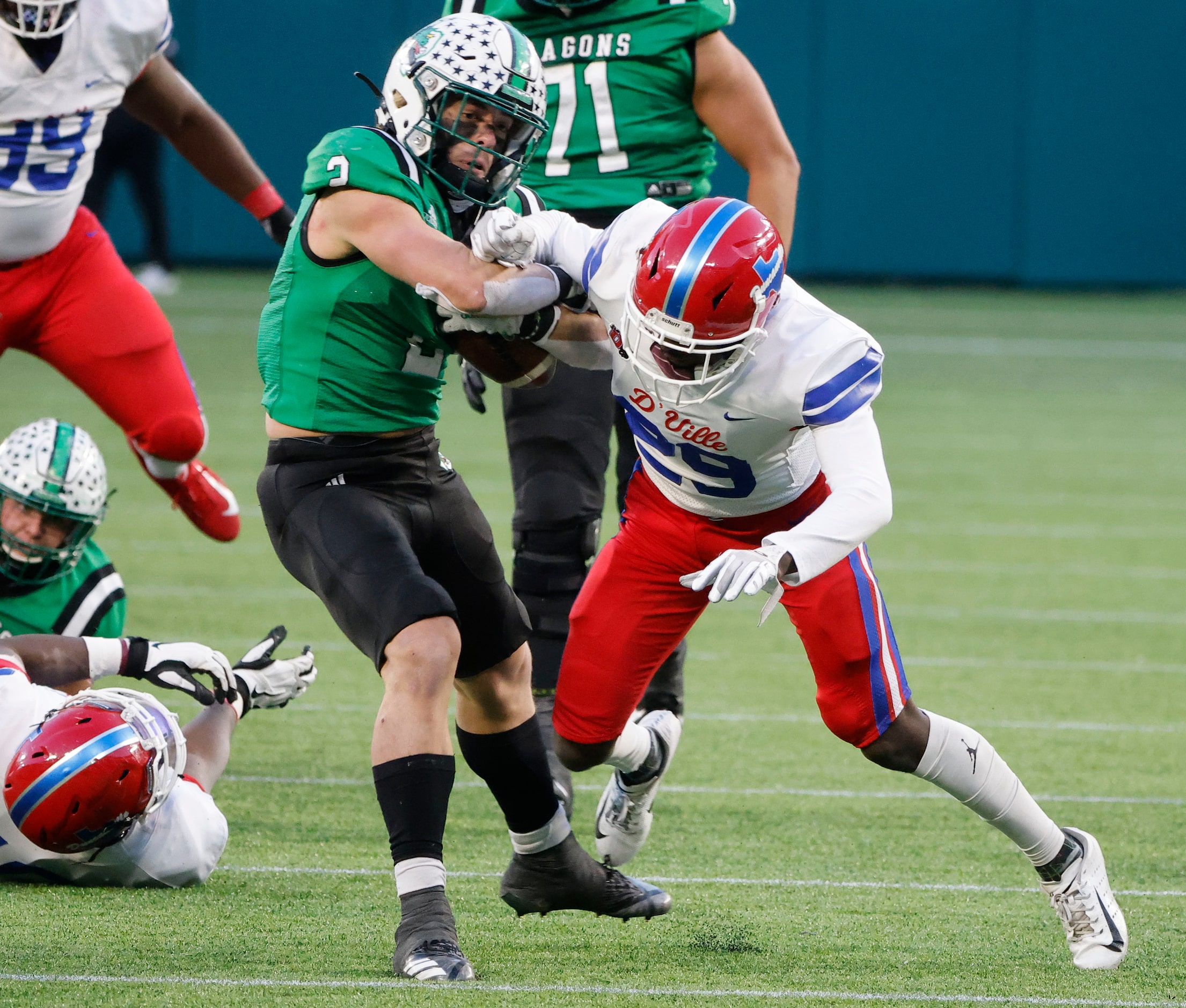 Southlake running back Owen Allen bounces off an attempted tackle by Duncanville defender...