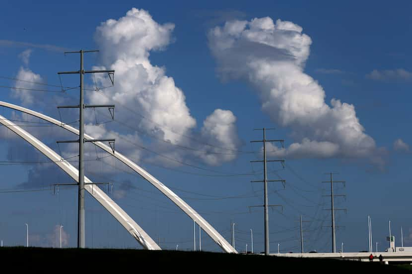 Large electrical transmissions lines are pictured along the Trinity River levee and Margaret...