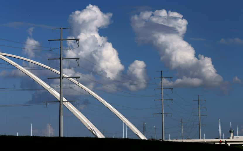 Large electrical transmissions lines run along the Trinity River levee and Margaret...