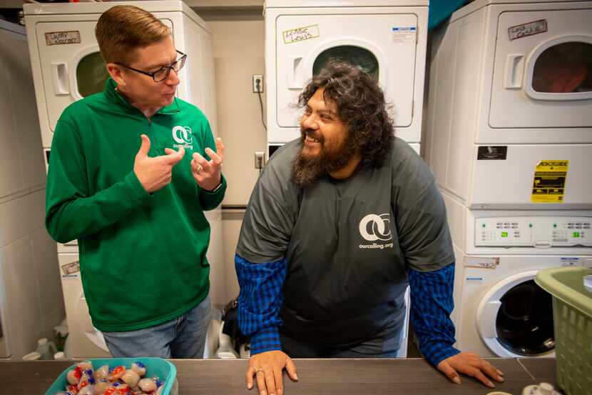 Wayne Walker talks with volunteer John Garcia who works doing laundry for homeless people at...