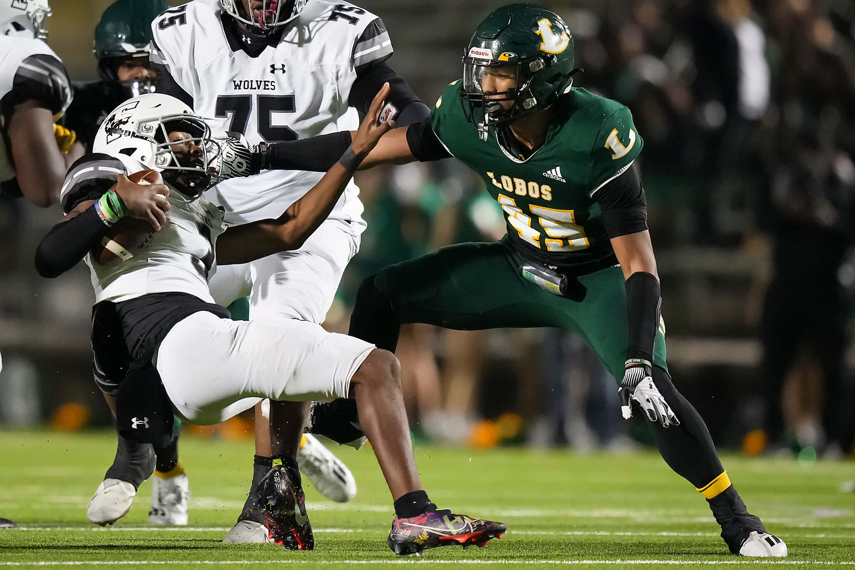 Mansfield Timberview quarterback Cameron Bates (3) is sacked by Longview defensive lineman...