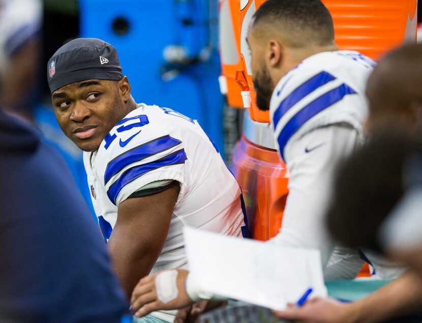 Dallas Cowboys wide receiver Amari Cooper (19) talks with quarterback Dak Prescott (4) on...