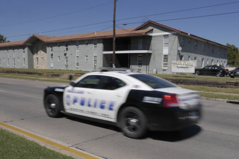 A Dallas police cruiser passes the Delta Plaza Apartments. The city has vowed to clean up...