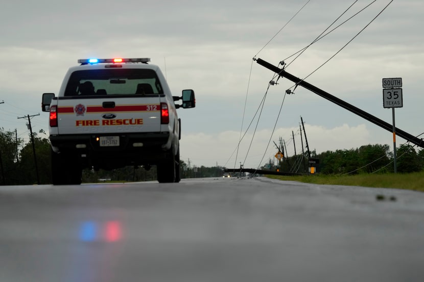 Power lines downed by the effects of Hurricane Beryl block a highway near Palacios, Texas,...