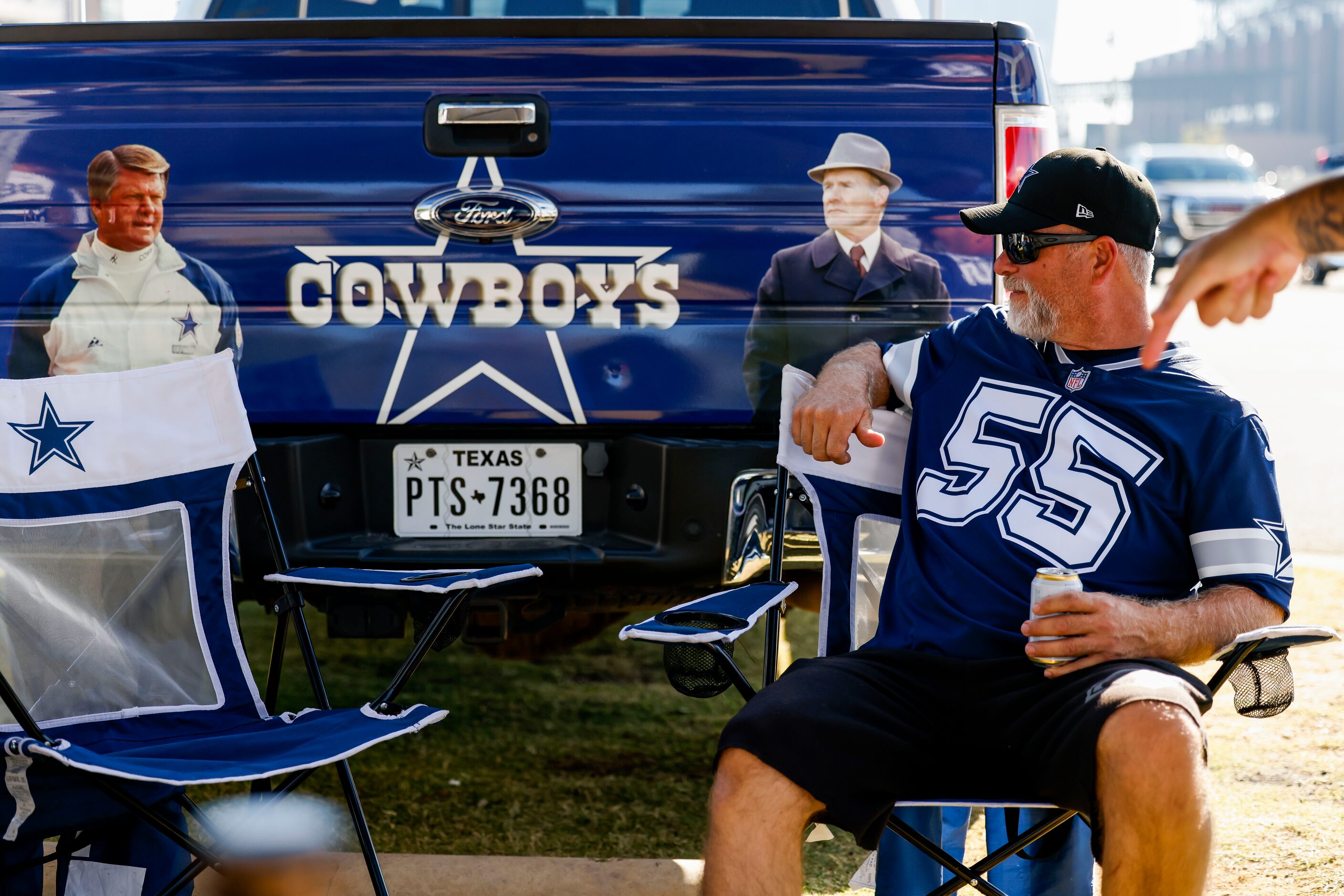 Tony Van Der Boon sits in front of a Cowboys decorated truck while tailgating before the...