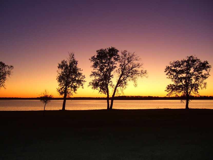 "Glowing Sunset" by Dianna Storrusten showcases Lake Pat Cleburne at dusk. 