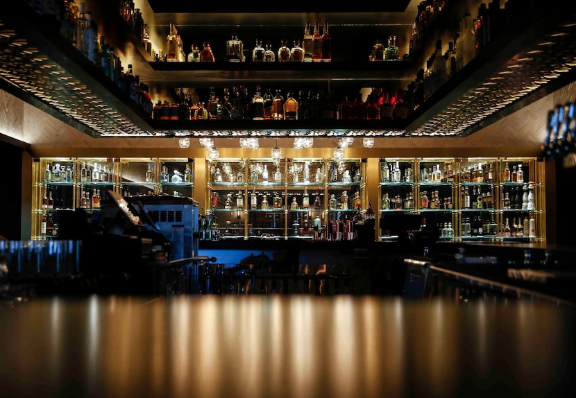 In the back of the bar, hundreds of bottles of tequila are on display.