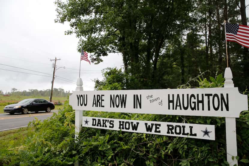 A sign in front of a residence along Elm Street mentions Dallas Cowboys quarterback Dak...