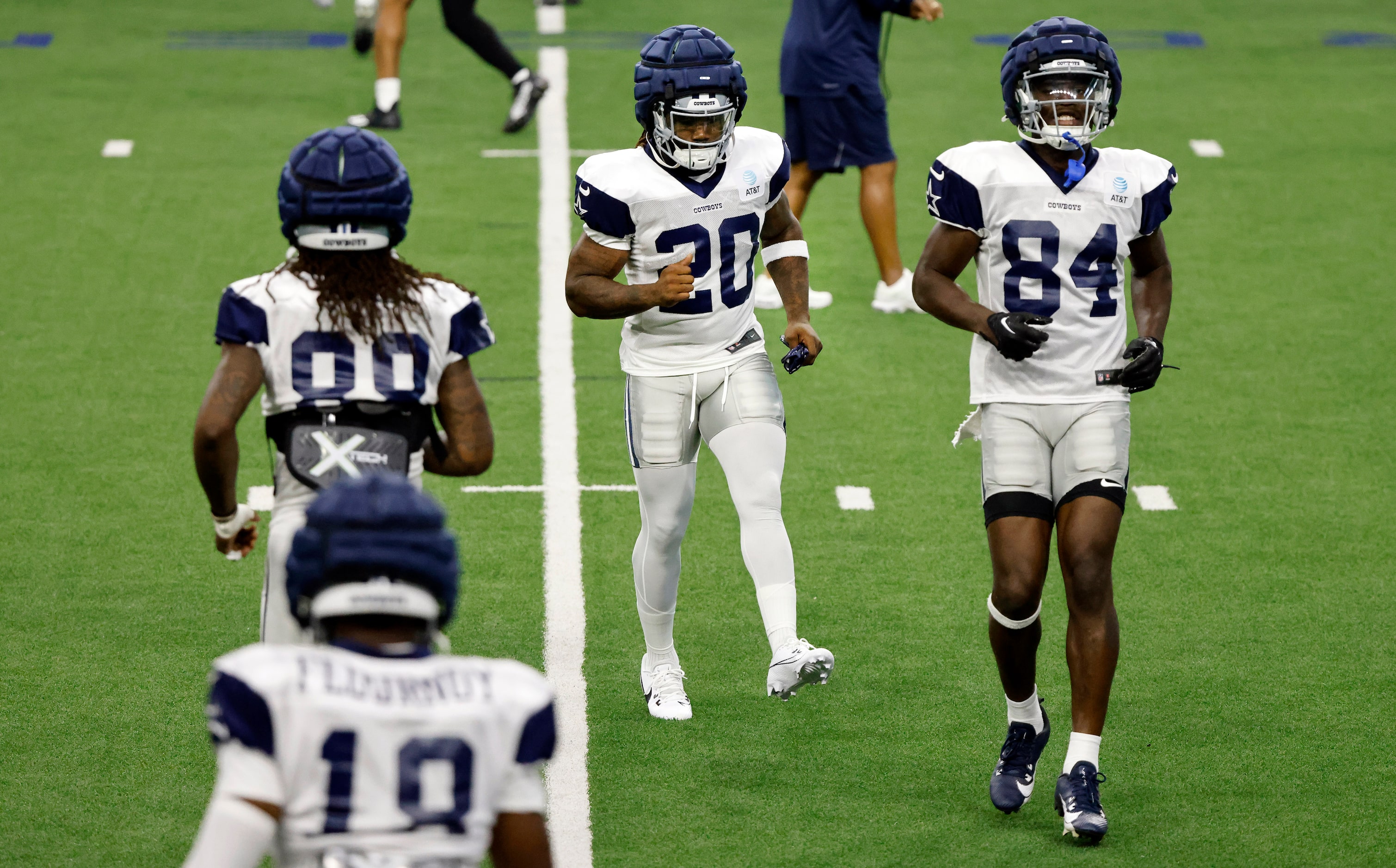 Dallas Cowboys running back Dalvin Cook (20) stretches with his new teammates as he joined...