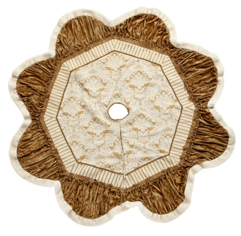 Surround a Christmas tree with a 72-inch round, ivory and gold tree skirt trimmed in faux...