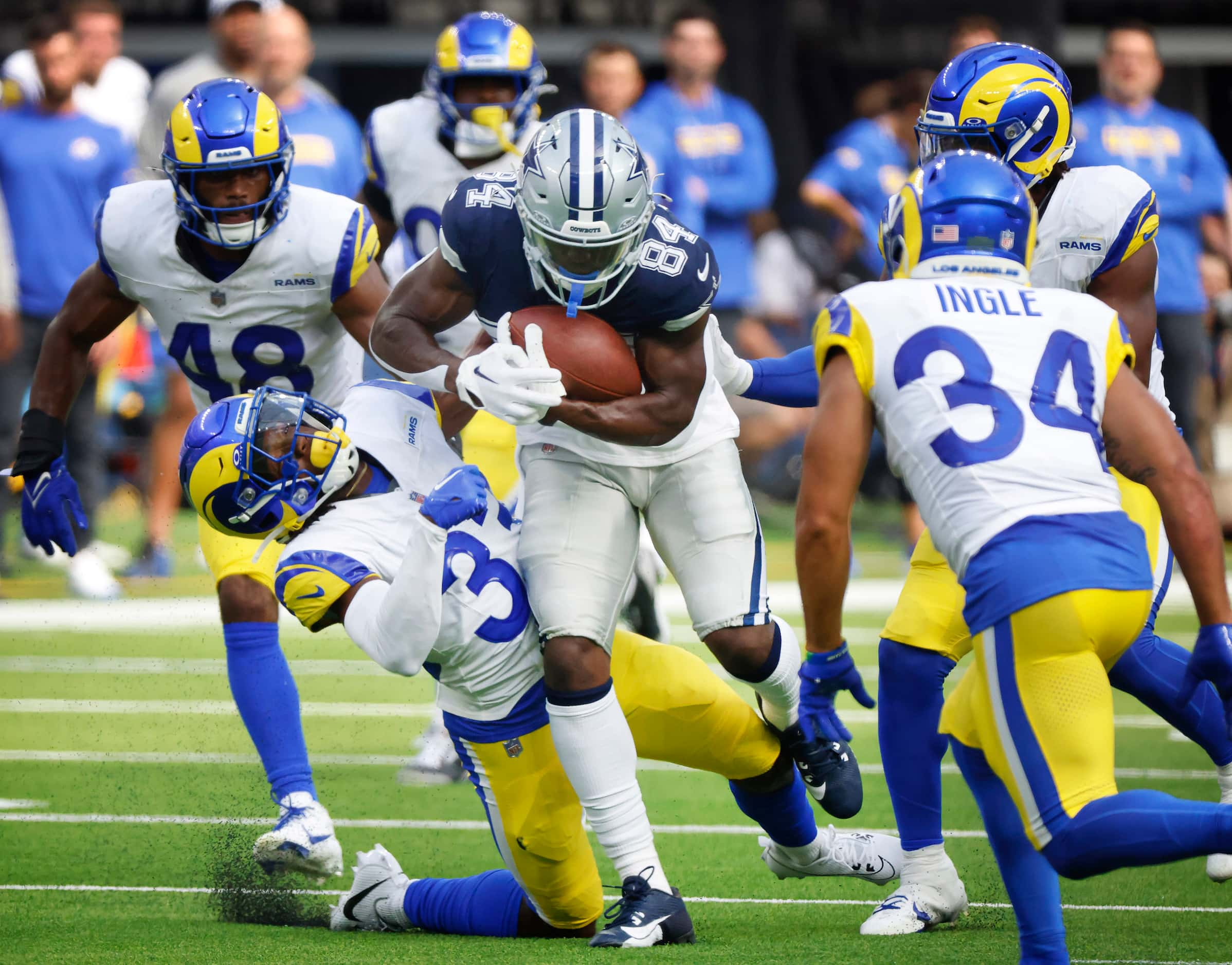 Dallas Cowboys wide receiver Kelvin Harmon (84) bowls over Los Angeles Rams cornerback Cam...