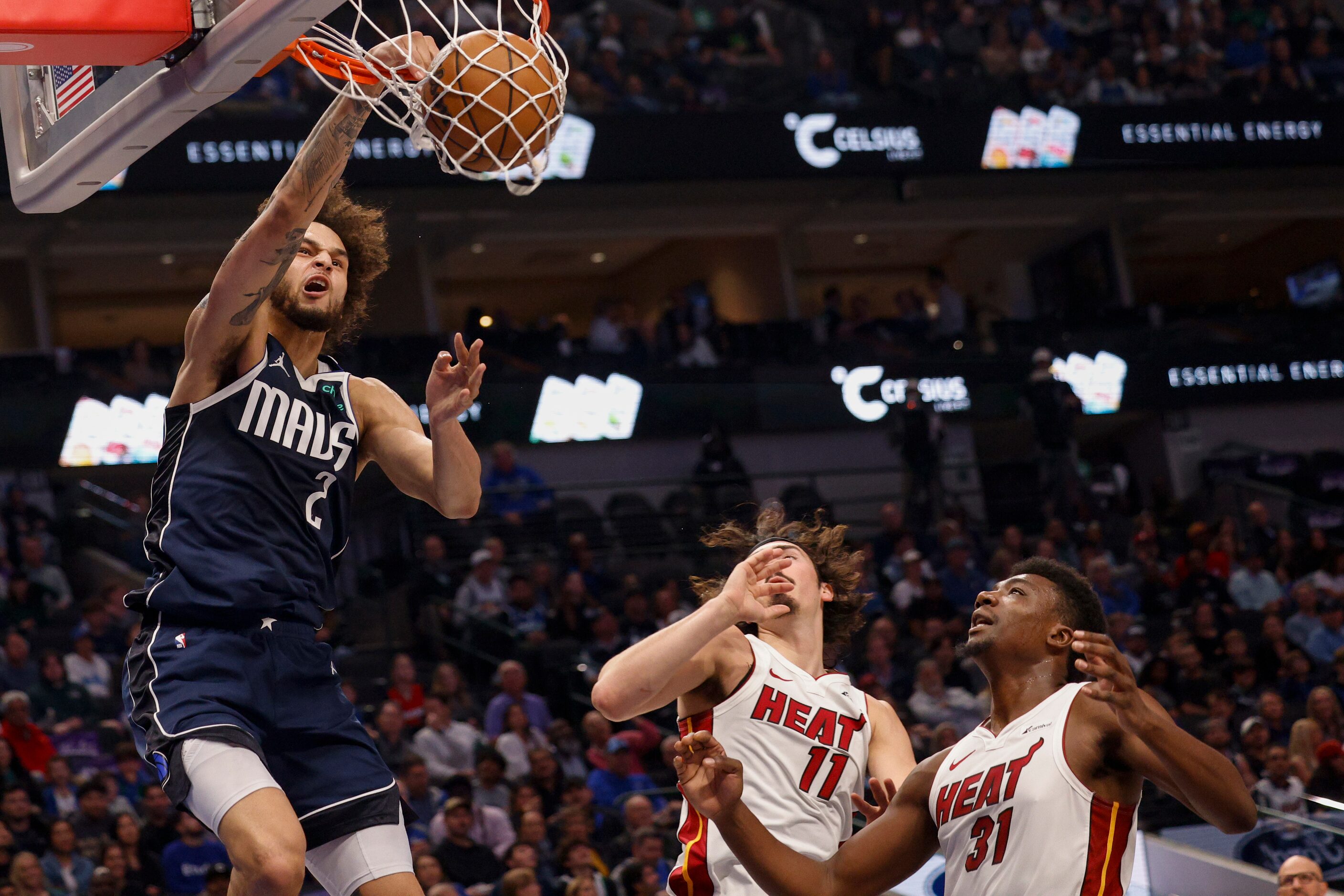 Dallas Mavericks center Dereck Lively II (2) dunks the ball over Miami Heat guard Jaime...