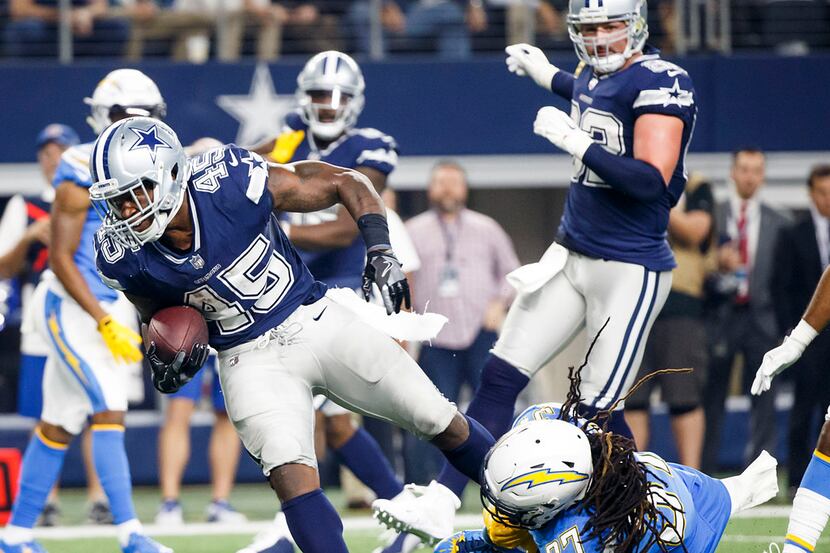 Dallas Cowboys running back Rod Smith (45) is tripped up by Los Angeles Chargers strong...