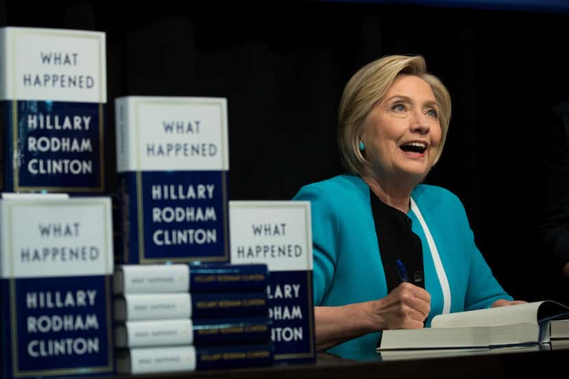 Former U.S. Secretary of State Hillary Clinton signs copies of her new book What Happened...