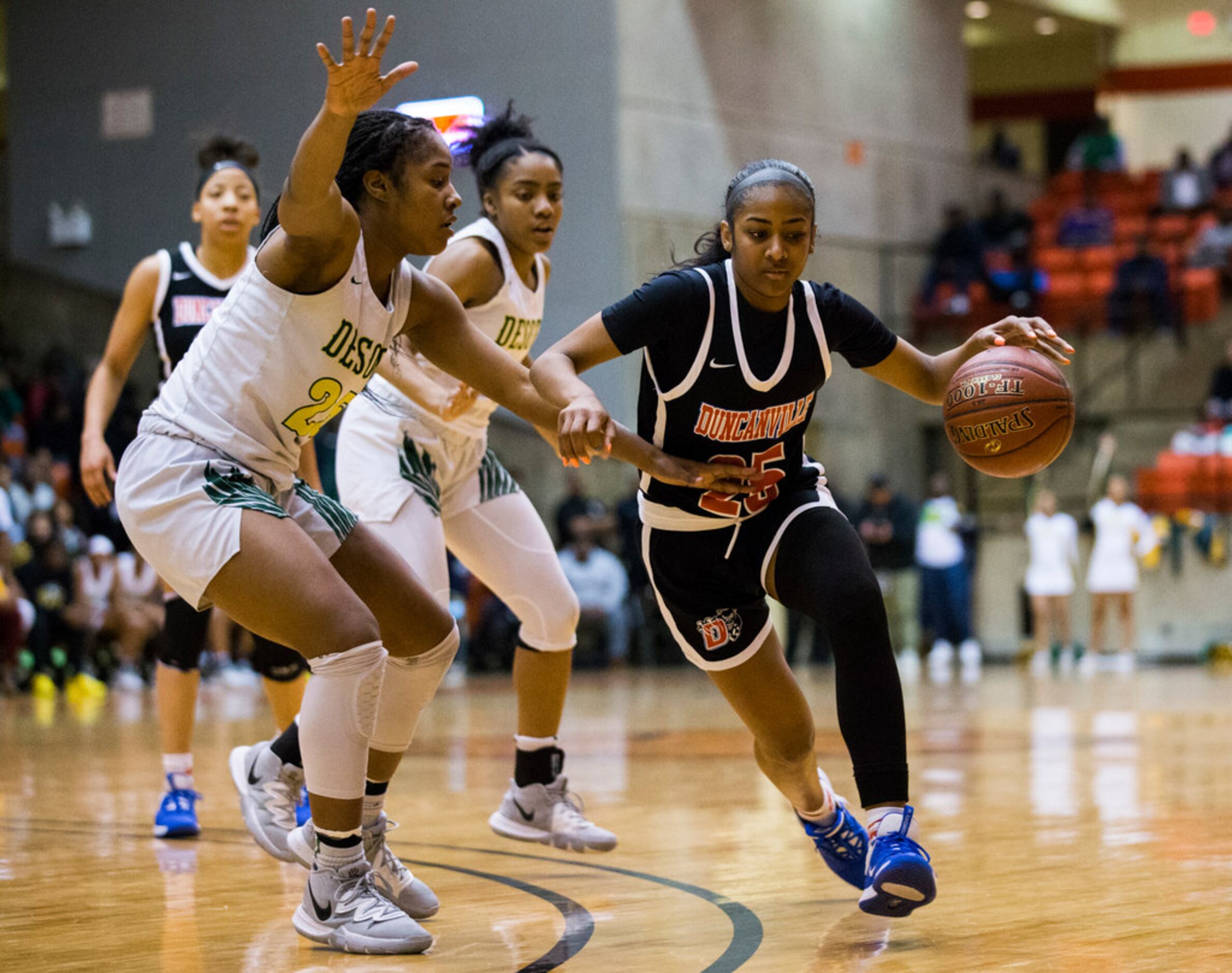 Duncanville's Deja Kelly (25) gets around DeSoto's Ash'a Thompson (25) during the fourth...