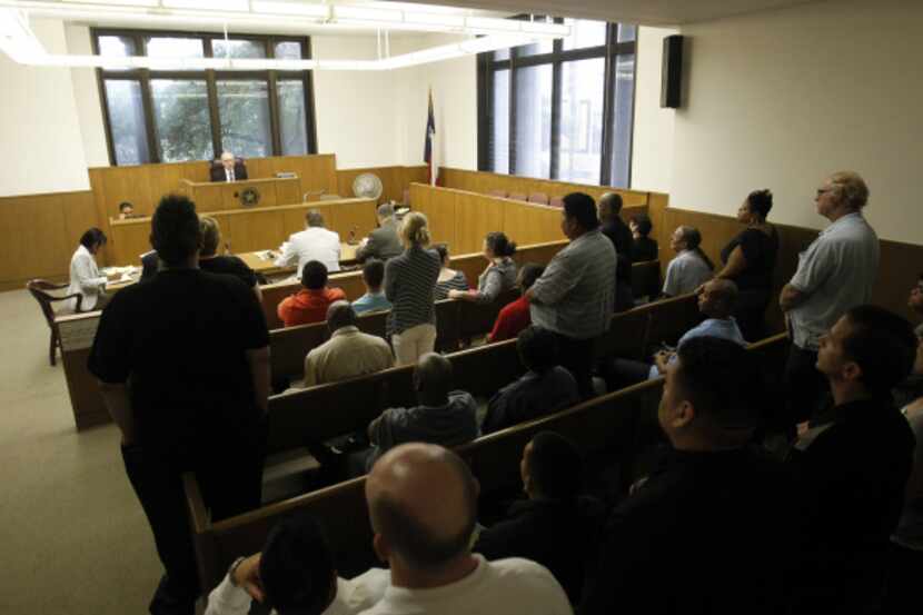 A group of people are dismissed from a hearing at Dallas Municipal Court in 2019.