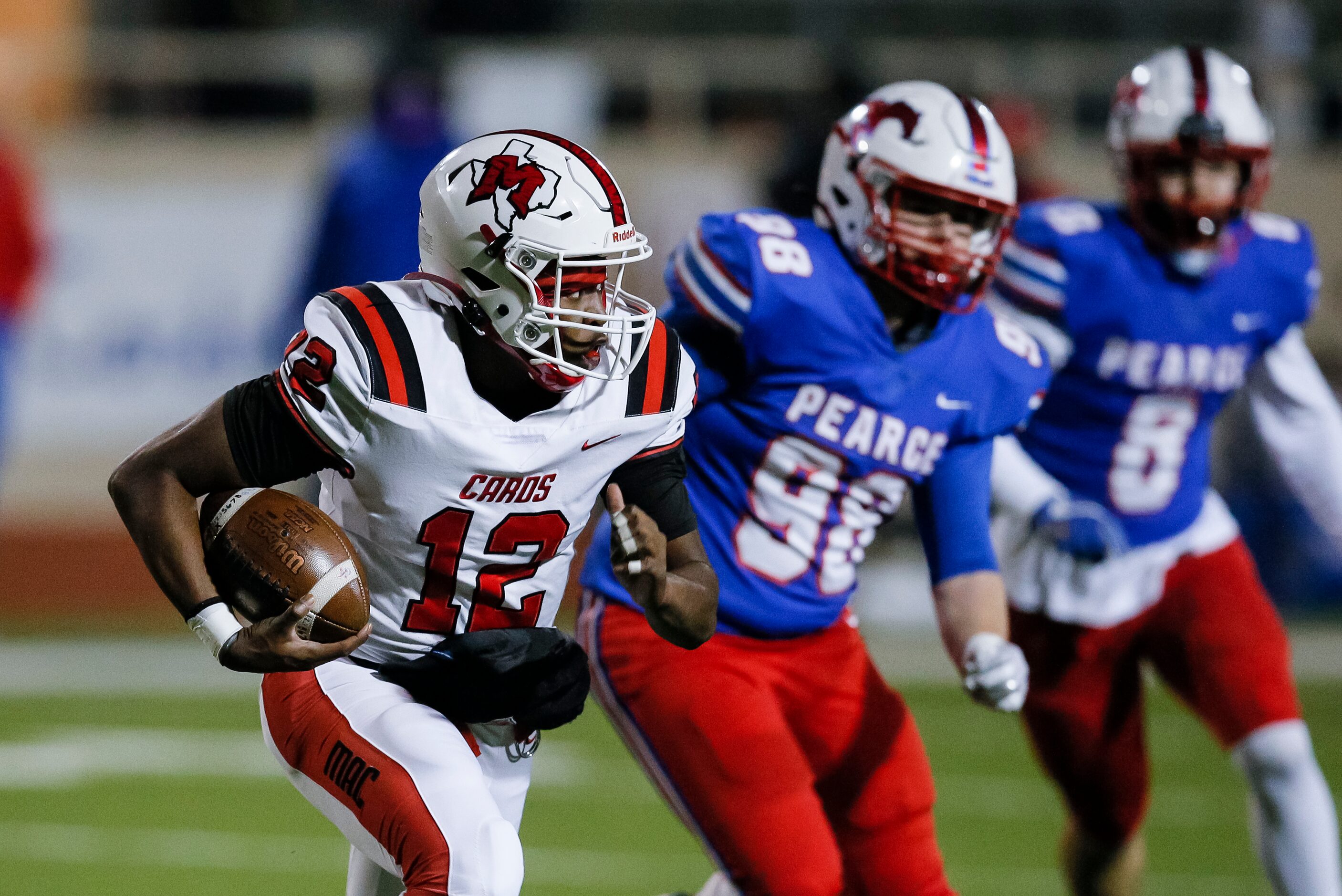 Irving MacArthur sophomore quarterback Kyale Flye (12) looks for room against the JJ Pearce...