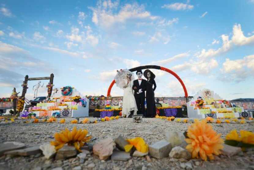 
Surrounded by fresh marigolds, participants in the annual Dia De Los Muertos celebration in...