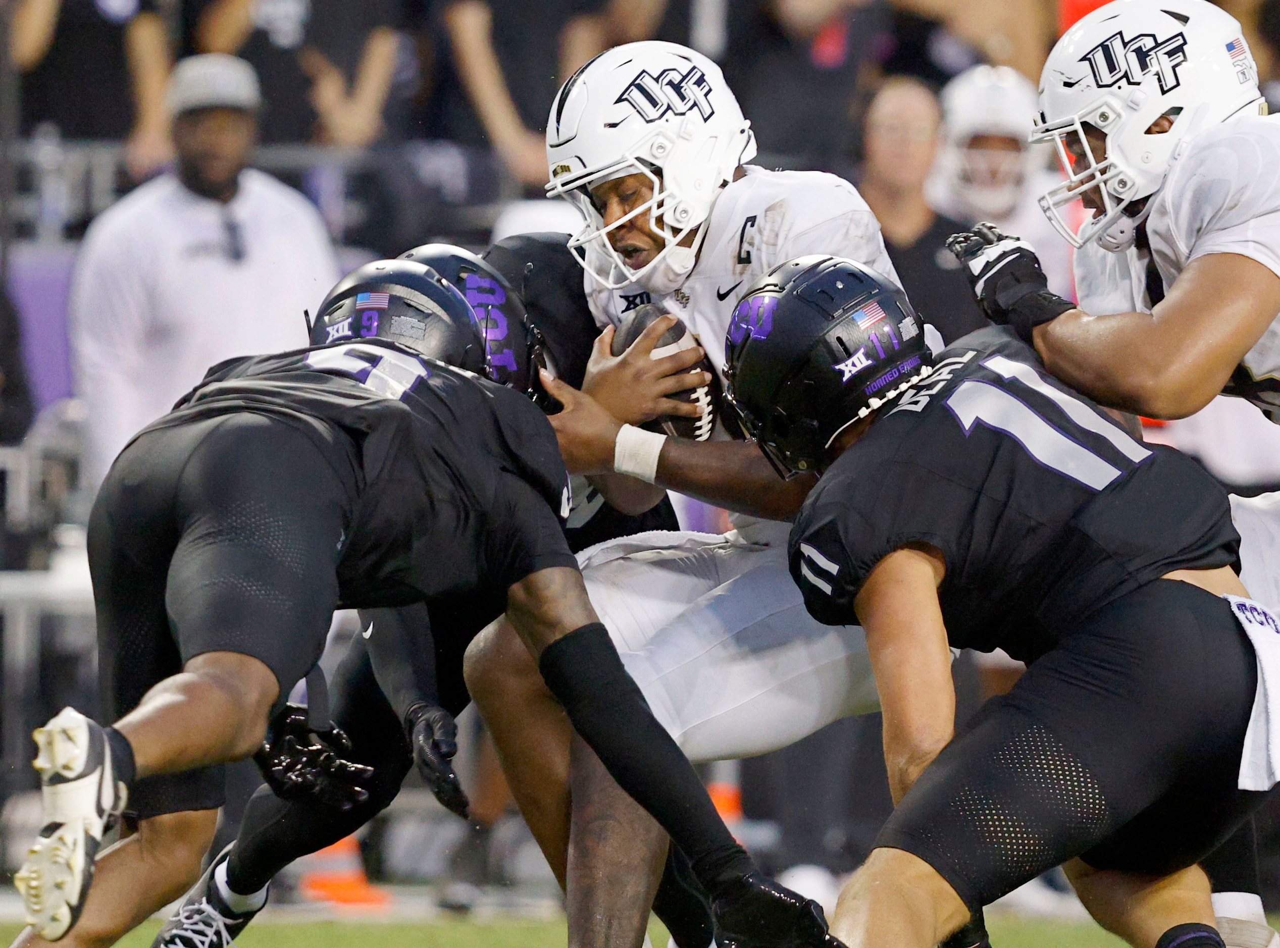 UCF quarterback KJ Jefferson (1) is tackled by TCU linebacker Marcel Brooks (9 and TCU...