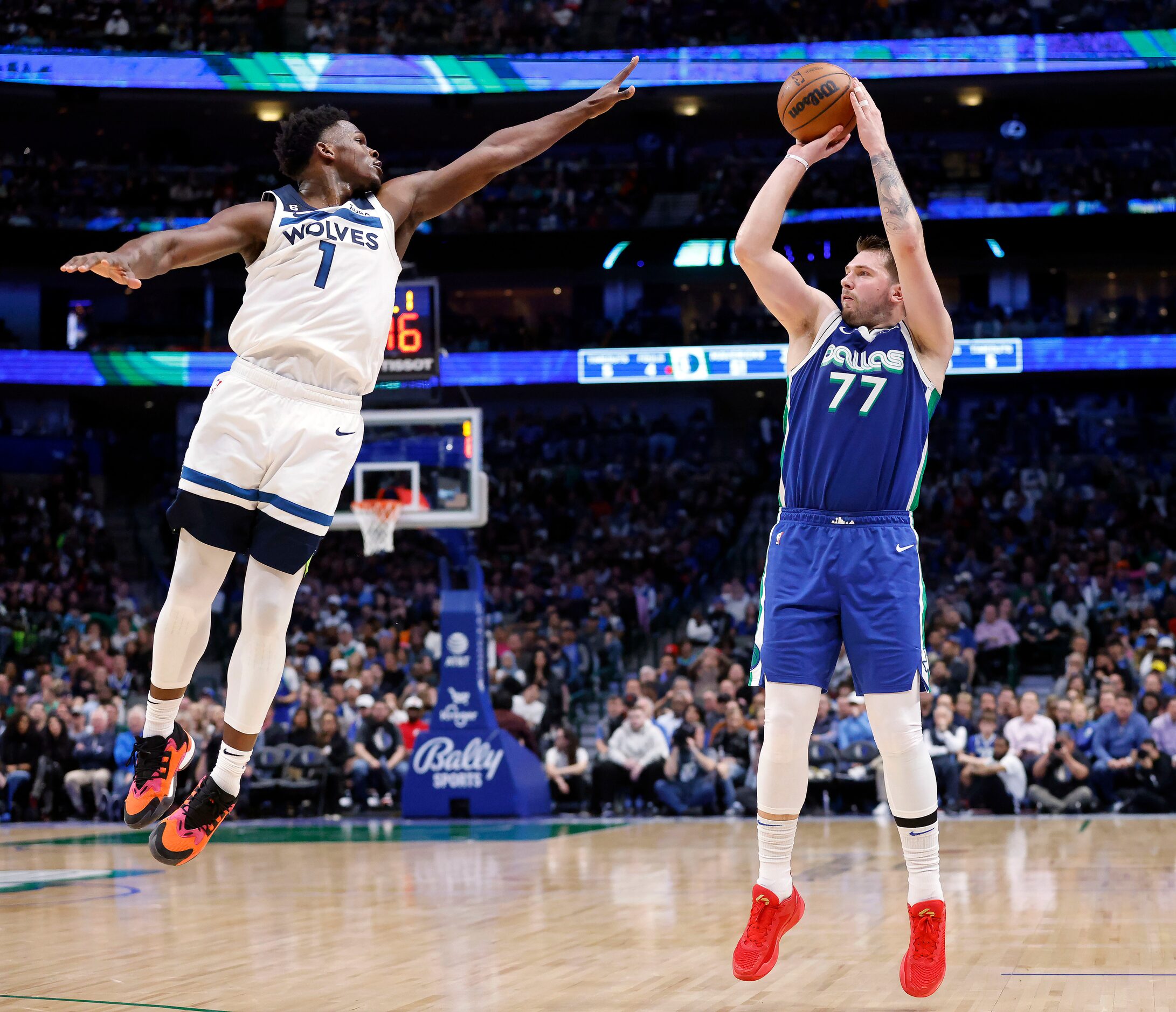 Dallas Mavericks guard Luka Doncic (77) puts up a three-pointer over Minnesota Timberwolves...