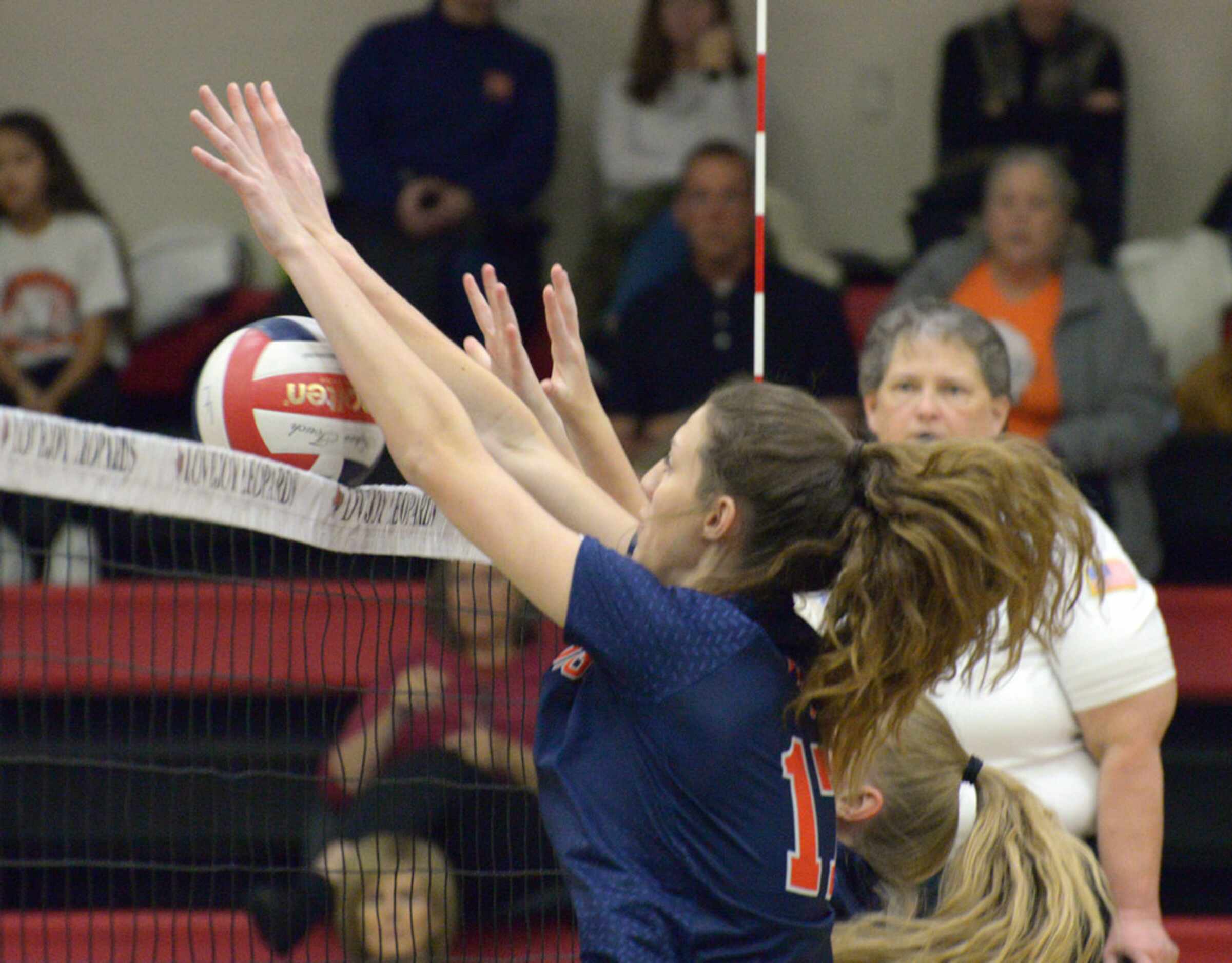 McKinney's North's Natalie Hughes blocks a shot during a  high school volleyball match...