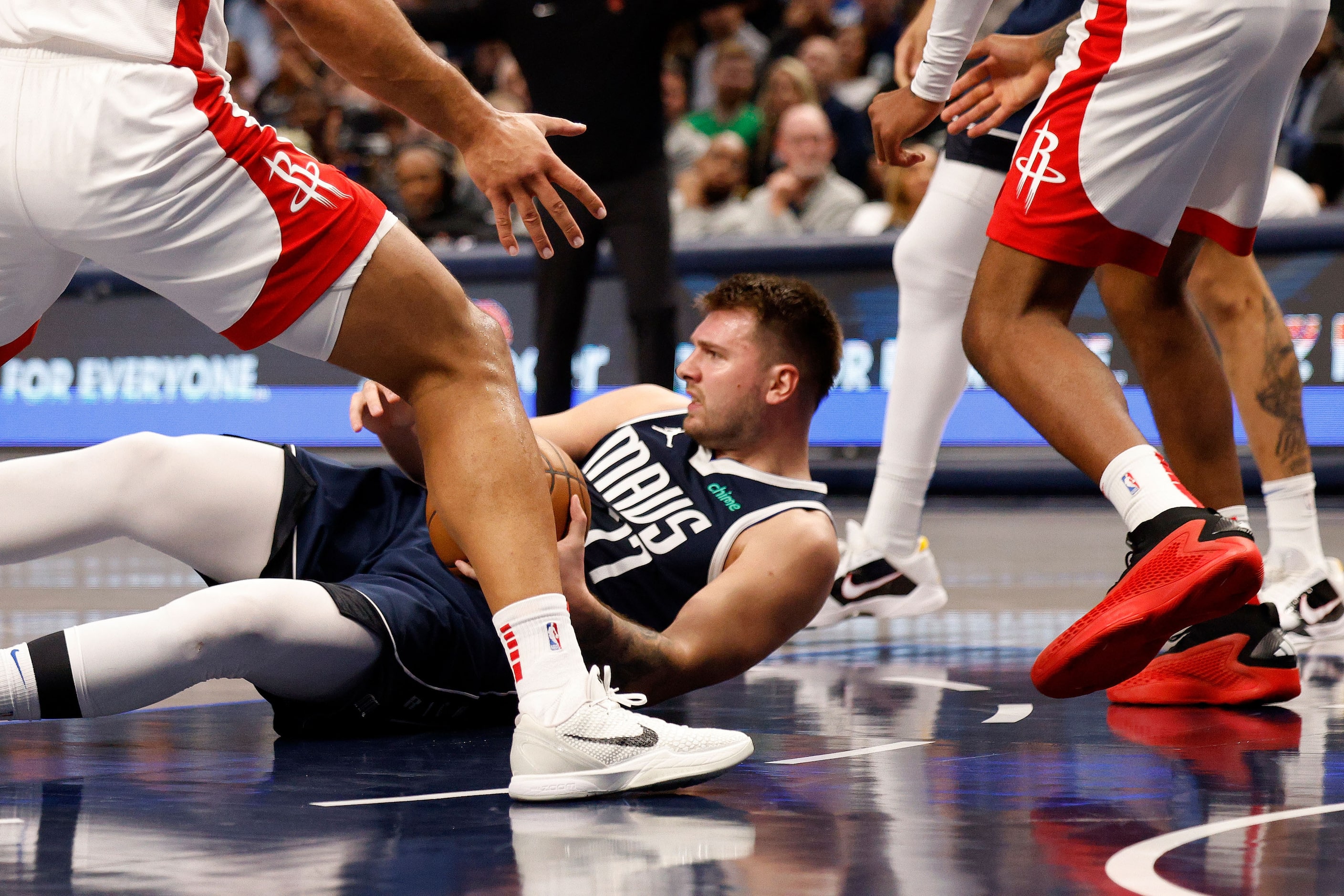 Dallas Mavericks guard Luka Doncic (77) falls down during the first half of an NBA...