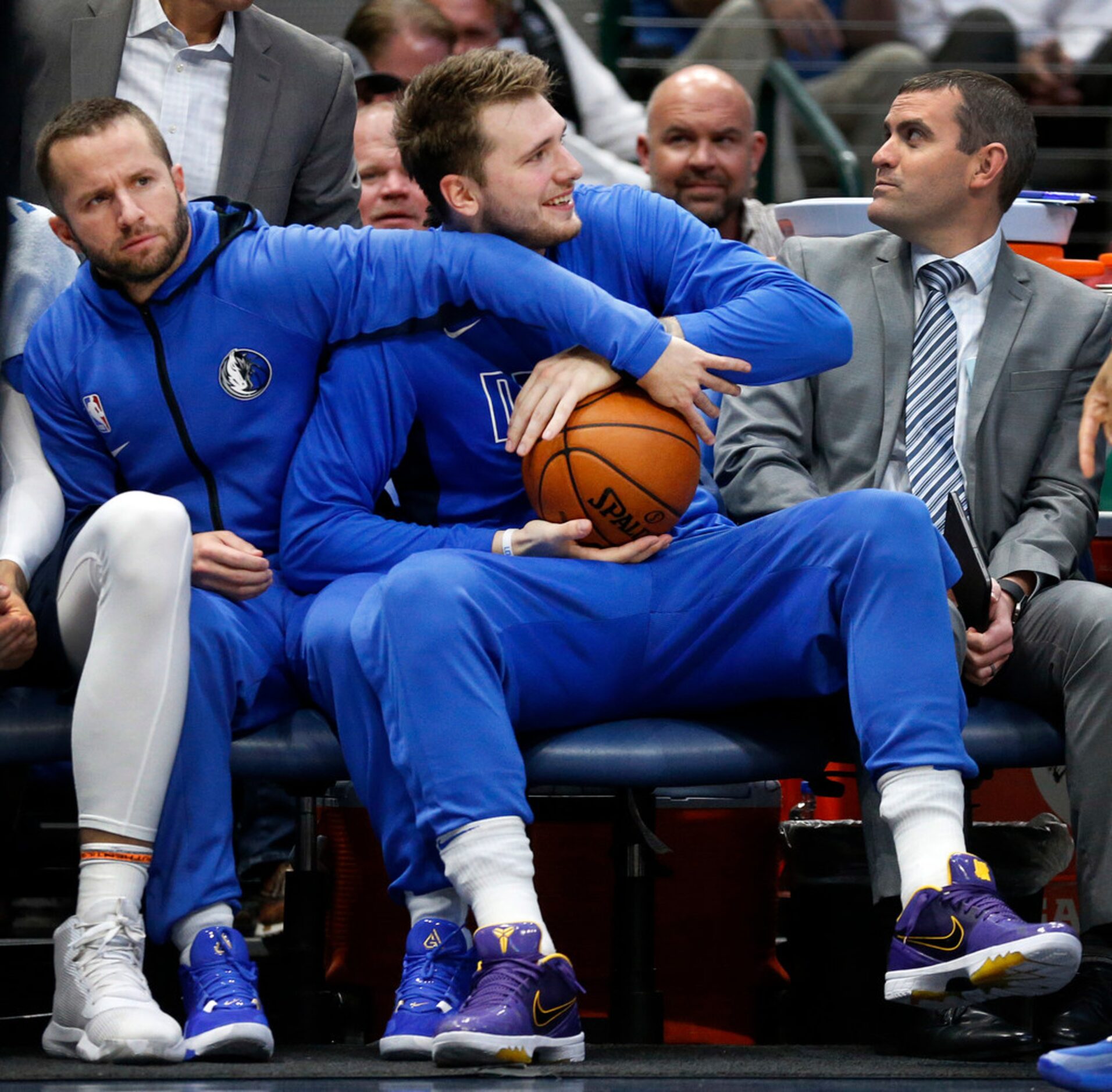 Dallas Mavericks guard J.J. Barea (left) and forward Luka Doncic (right) fight over a ball...