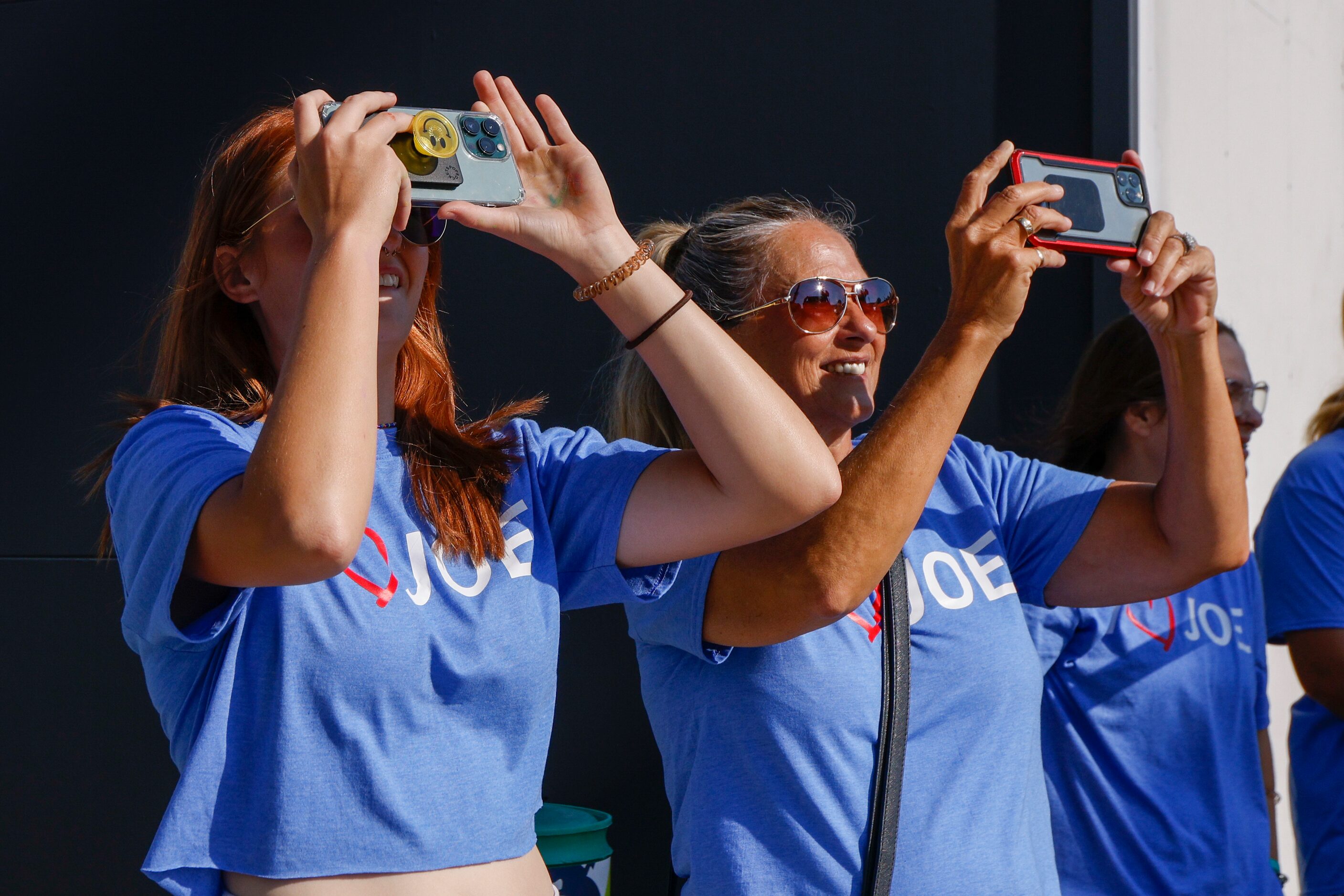 Morgan Kolanek, 17 (left), records a video as her father and crane operator Joe Kolanek...