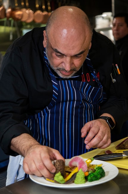 Chef Avner Samuel finishes a dish of za'atar crusted ahi.