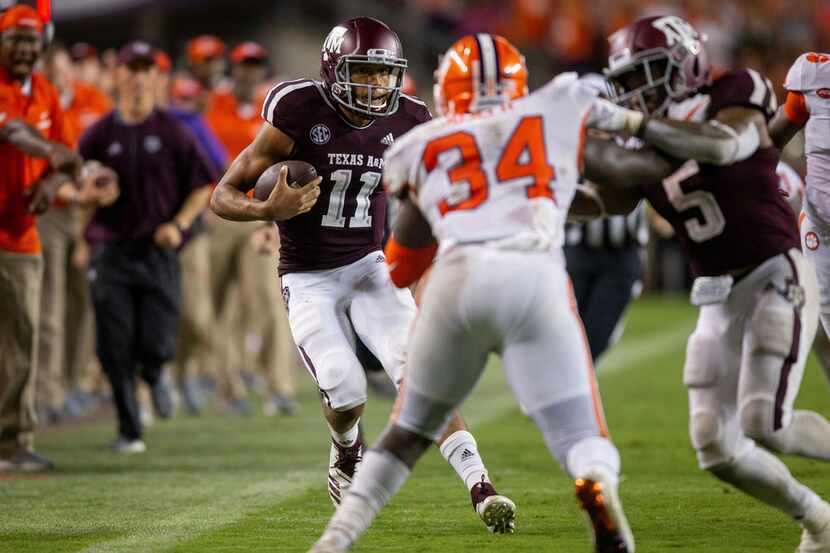 Texas A&M quarterback Kellen Mond (11) rushes down the sideline for a first down against...