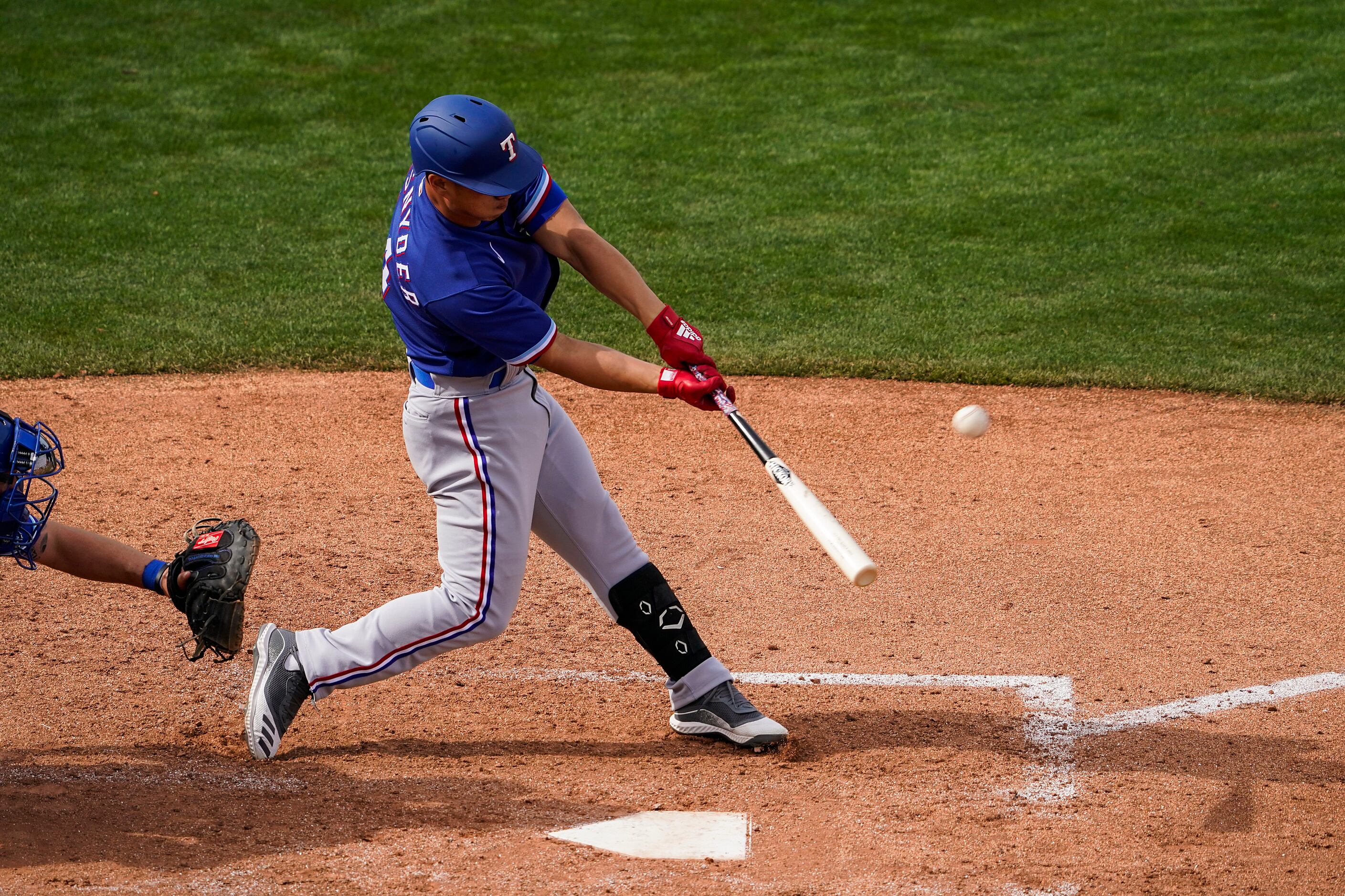 Texas Rangers outfielder Rob Refsnyder hits a 2-run home run during the seventh inning of a...