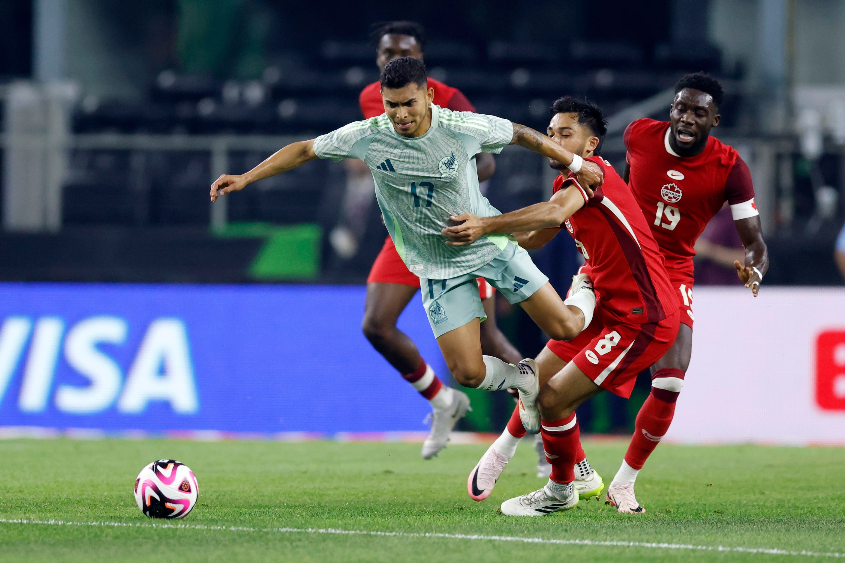 Canada midfielder Mathieu Choiniere (8) tackles Mexico midfielder Orbelin Pineda (17) during...