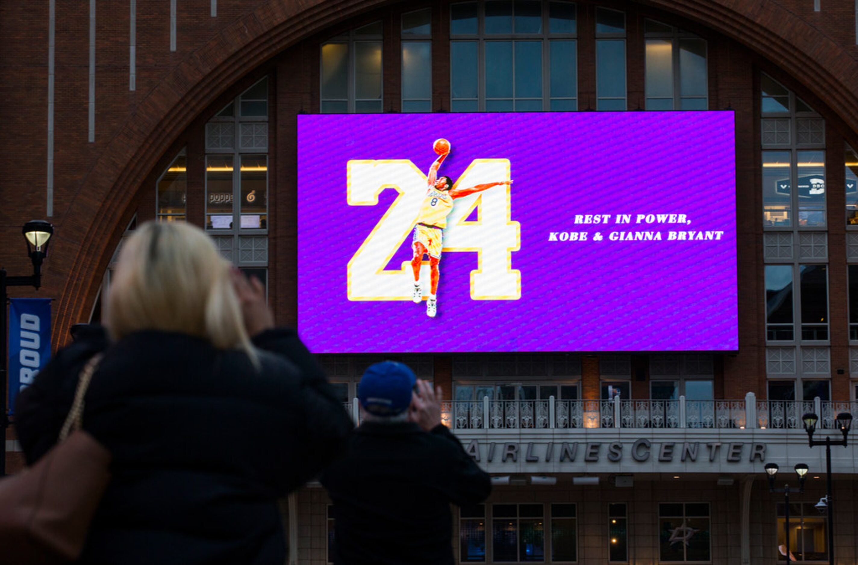 Large screens display a tribute to former Los Angeles Laker Kobe Bryant and his daughter,...