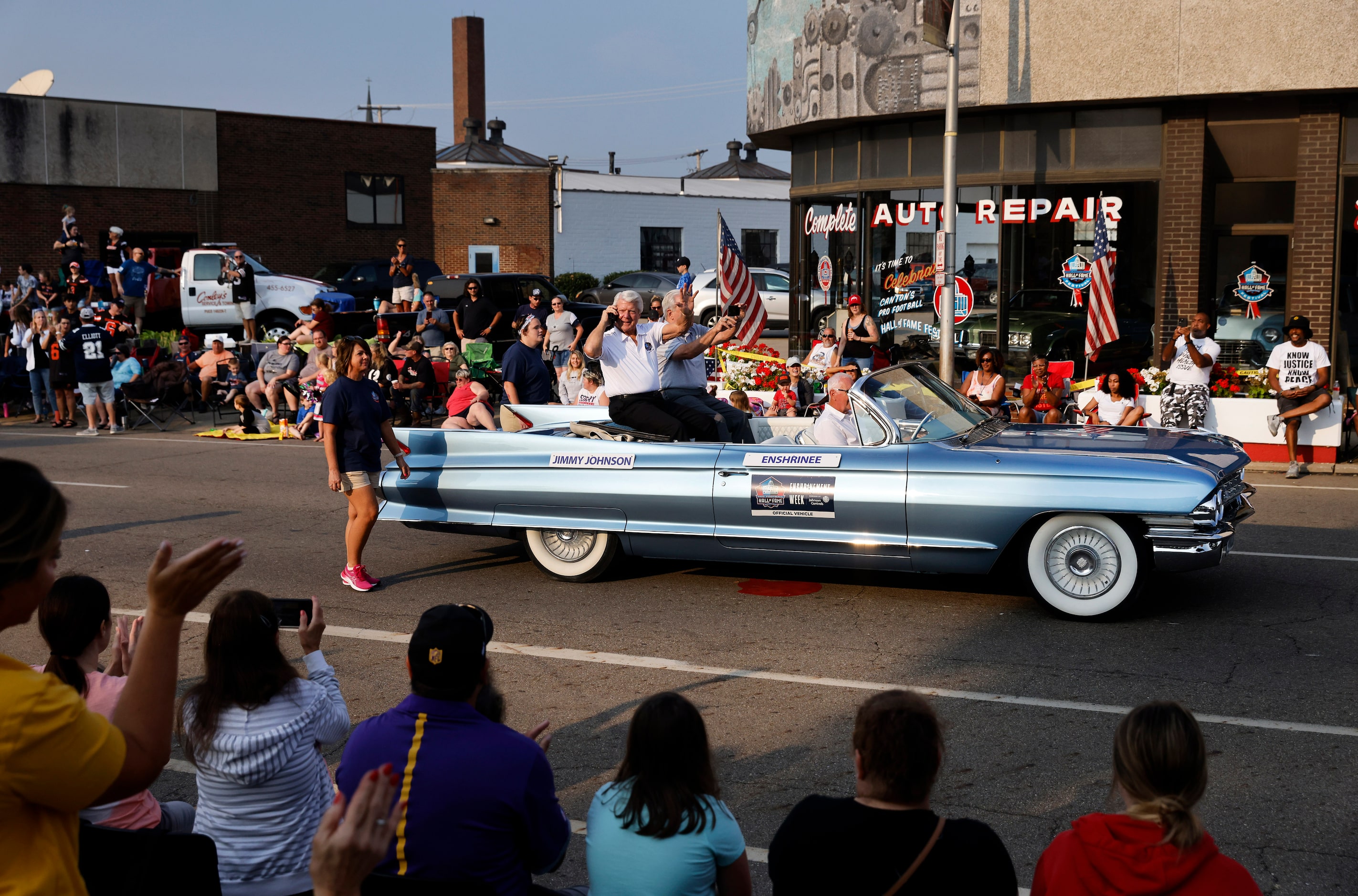 Dallas Cowboys head coach and Pro Football Hall of Fame inductee Jimmy Johnson waves to fans...