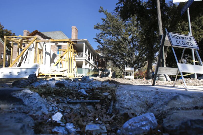Construction workers worked on house and sidewalk in Highland Park on Nov. 21.