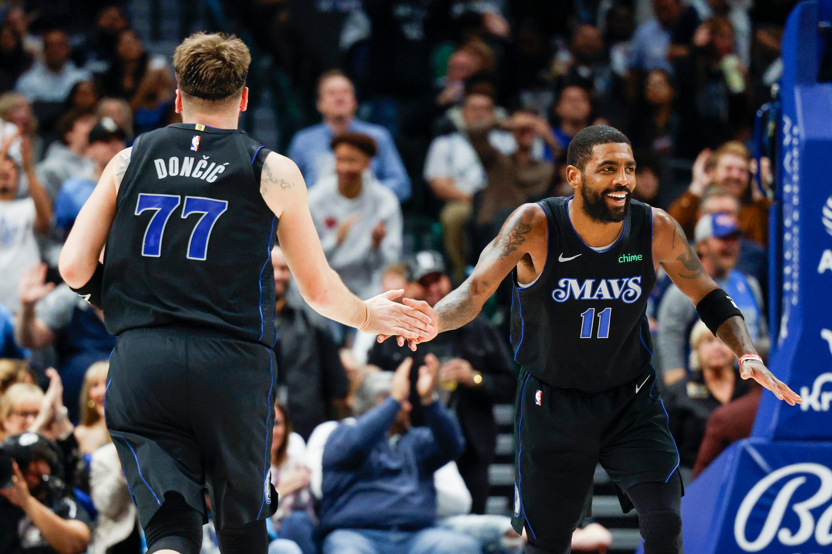 Dallas Mavericks guard Luka Doncic (77) high-fives guard Kyrie Irving (11) during the first...