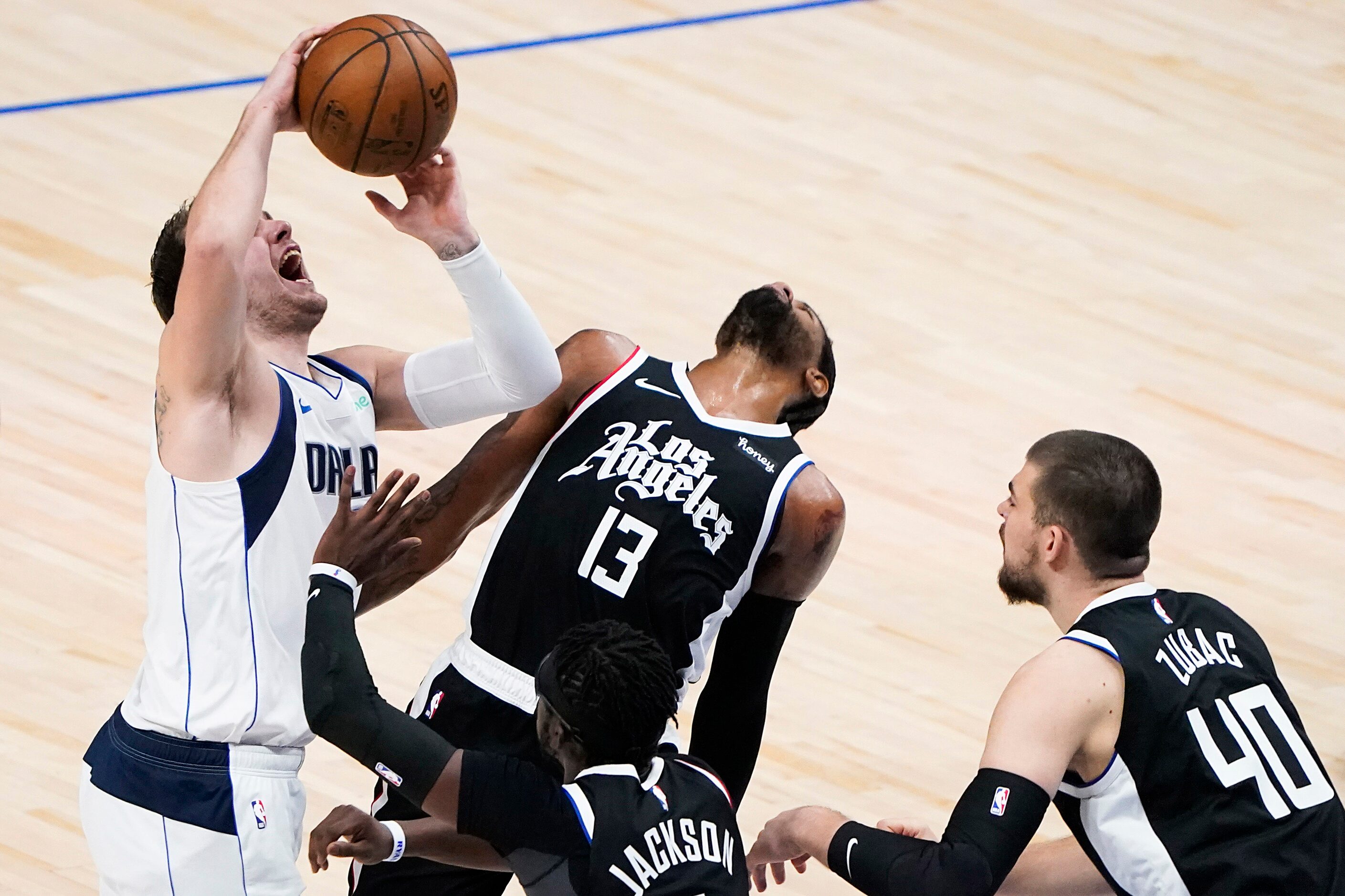 Dallas Mavericks guard Luka Doncic (77) loses the ball as LA Clippers guard Paul George (13)...