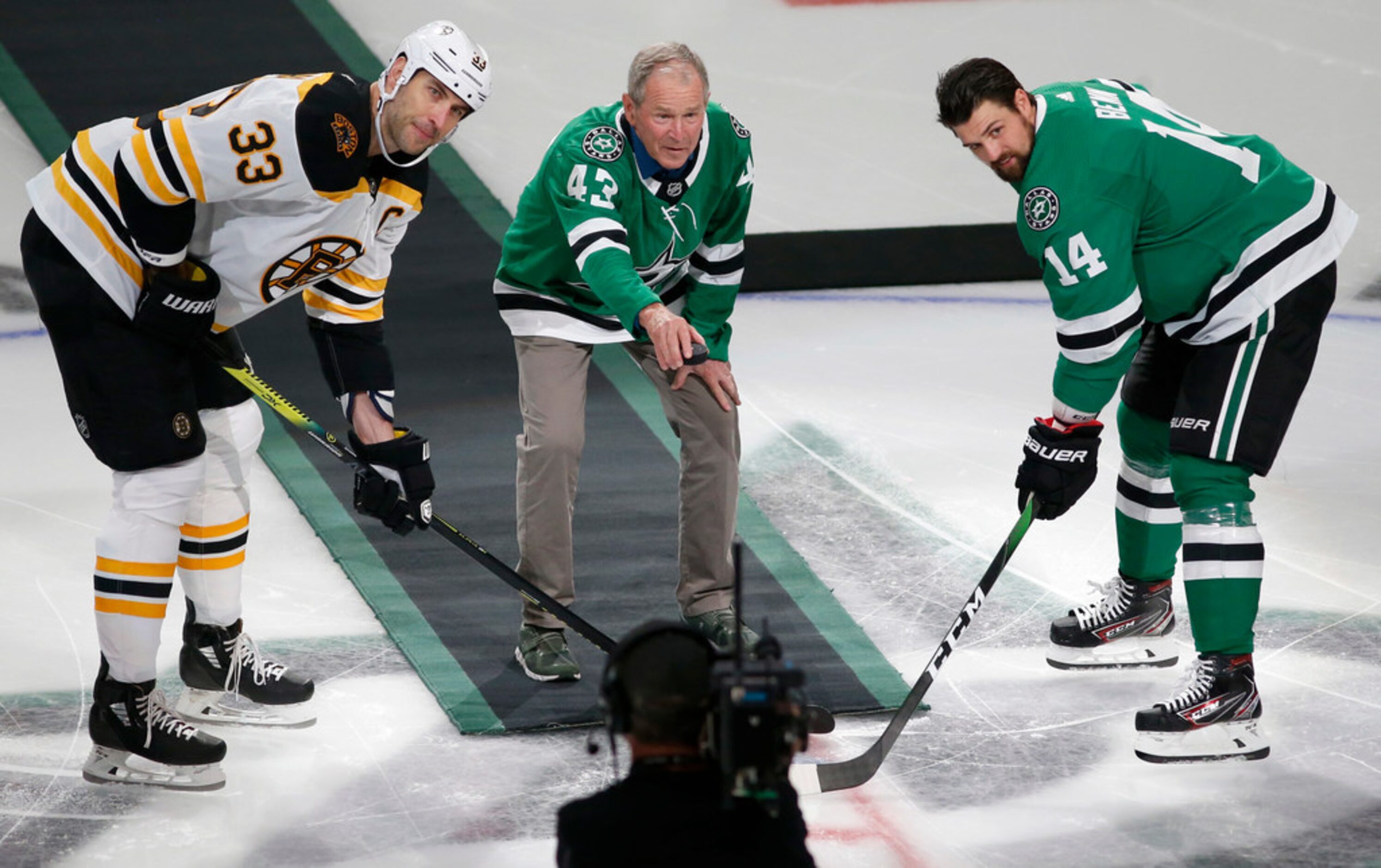 Former President George W. Bush prepares to drop the puck as Boston Bruins defenseman Zdeno...