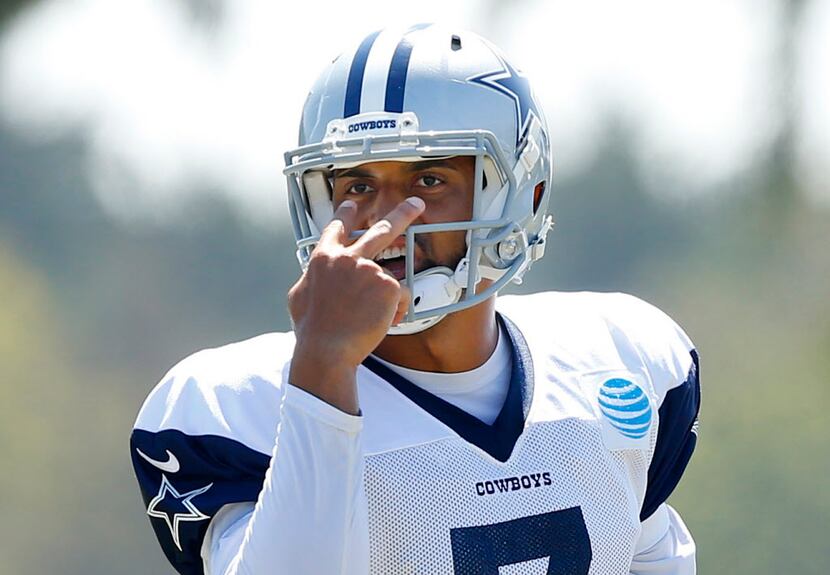 Dallas Cowboys quarterback Jameill Showers (7) signals to his receivers before running a...