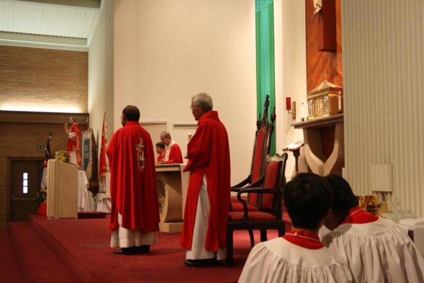 
Father Pham Minh (left) addresses the parish of St. Peter Vietnamese while two altar boys...