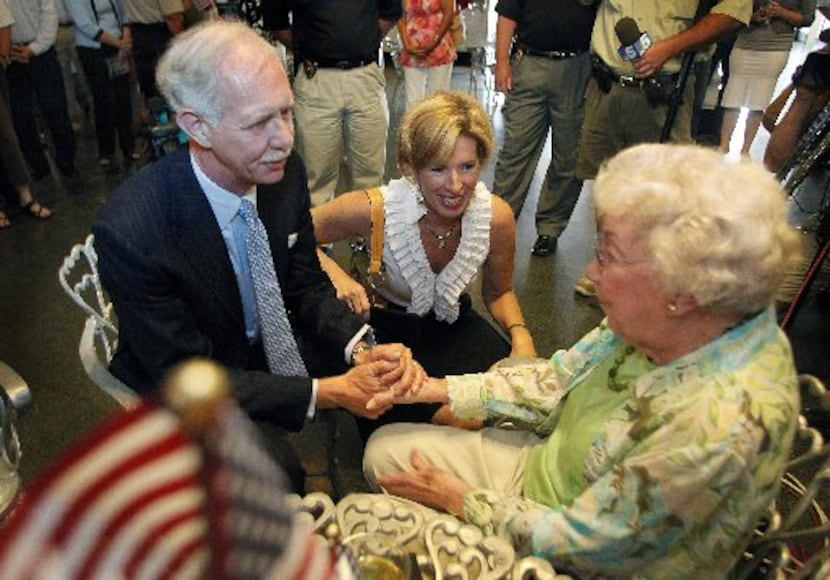 Capt. Chesley "Sully" Sullenberger (left) and his wife, Lorrie (center), greet Evelyn Cook...