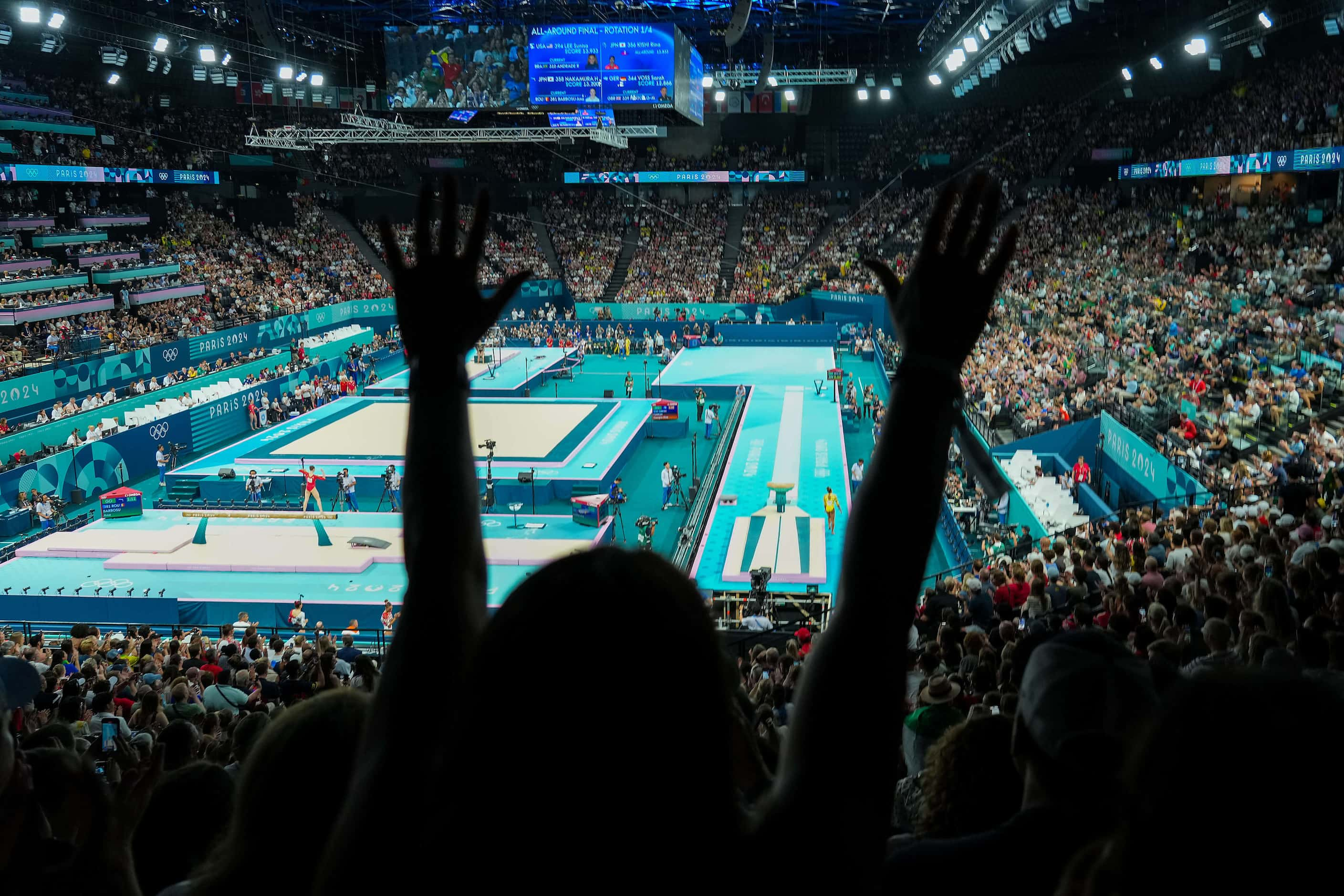 Fans cheer after Rebeca Andrade of Brazil competed on the vault during the women’s...