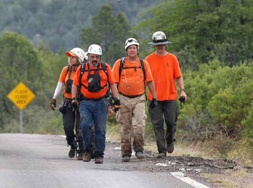Members of the Tonto Rim Search and Rescue team walk back to the Gila County Sheriff's...